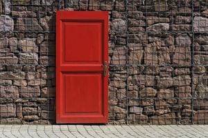 red 2-panel door on black metal chain link board photo