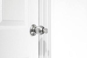 Installing locking knob with key at the door inside the home photo