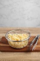 Cooked spaghetti in metal bowl on cuttingboard photo