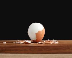 boiled egg on wooden cutting board photo