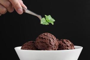 Food stylist use tweezers decorating fake icecream photo