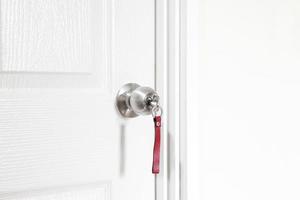 Installing locking knob with key at the door inside the home photo