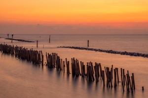 Bamboo wall and stone wall for protection . Samut Sakhon, Thailand photo