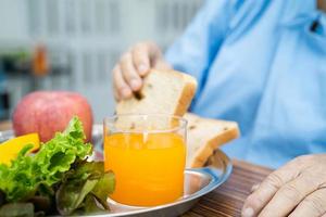 Asian senior woman patient eating breakfast in hospital. photo