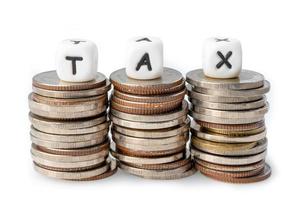 TAX alphabet on stack of coins photo