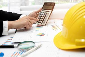 Architect or engineer working project accounting with graph photo