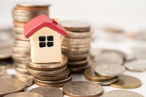 House on stack coins, mortgage home loan finance concept. photo