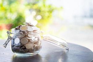Save money coins in grass jar, Business finance investment concept.