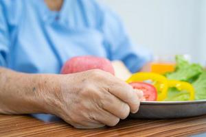 Asian senior  woman patient eating breakfast photo