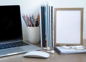 Laptop with office supplies on the table. photo