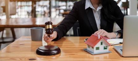 Gavel on sounding block in hand's female judge at a courtroom photo