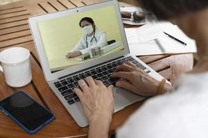 senior woman consult doctor via video call photo