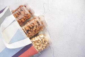 walnut , cashew nut and almond in a container on table photo