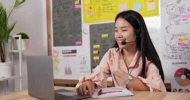 Woman with Headset Using Laptop and Talking video