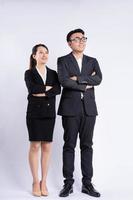 Asian businessman and business woman standing on white background photo