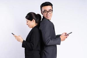 Asian businessman and businesswoman using smartphone photo