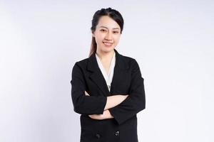 Young Asian businesswoman standing on white background photo