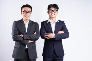 Two Asian businessman posing on white background photo