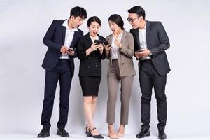 Group of Asian business people posing on a white background photo