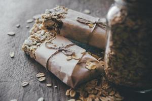 Homemade granola with nut mix in the glass jar on wooden board photo