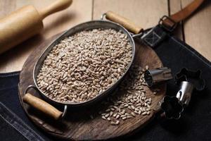 sunflower seeds in tray on the wooden background photo