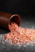 Himalayan pink salt in copper cup at kitchen photo