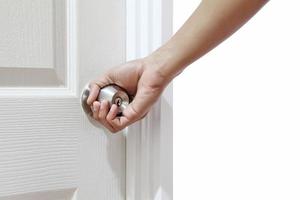 Man hand open door knob or opening white door photo