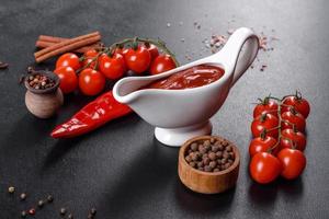 Red sauce or ketchup in a bowl and ingredients for cooking photo