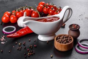 Red sauce or ketchup in a bowl and ingredients for cooking photo