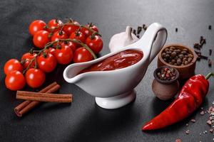 Red sauce or ketchup in a bowl and ingredients for cooking photo