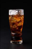 A glass of cola with ice and ice photo