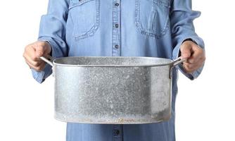 Hand holding vintage metal flower pot on white background photo