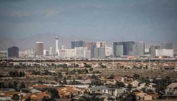 Las Vegas city surrounded by Red Rock mountains and Valley of Fire photo