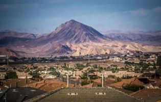 Las Vegas city surrounded by Red Rock mountains and Valley of Fire photo