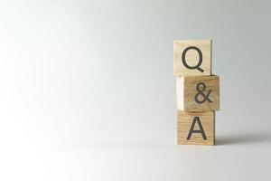 Q and A alphabet on wooden cube. photo