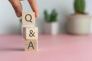 Q and A alphabet on wooden cube.