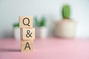 Q and A alphabet on wooden cube.