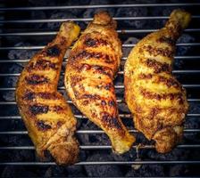 Spicy chicken drumsticks on the grill photo