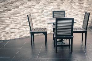 Outdoor patio with empty chair and table photo