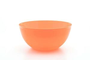 Orange plastic bowl on white background photo