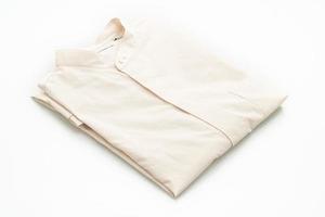 Beige shirt folded isolated on white background photo