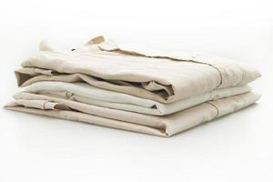 Beige shirts folded isolated on white background photo