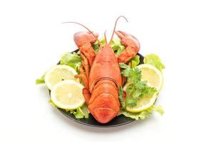 Freshly boiled lobster with vegetable and lemon isolated on white background photo
