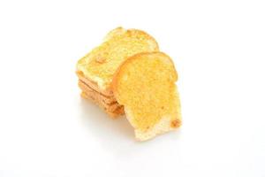 Baked crispy bread with butter and sugar isolated on white background photo