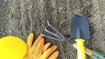 Close-up of garden tools lies on the excavated ground. photo