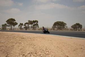 City, Country, MMM DD, YYYY - Motorcycle competition at a race track photo