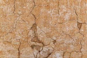 Brown adobe clay wall texture background. photo