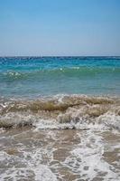 Clear sea and waves on the shore in summer