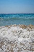Clear sea and waves on the shore in summer