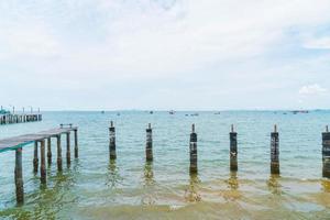 Wooden walking way on the beach leading to the sea photo